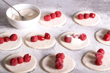 dumplings with frozen cherries are prepared in the kitchen