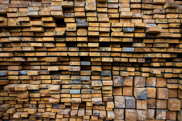 Wooden beams lie in a row. Woodworking and logging industry.