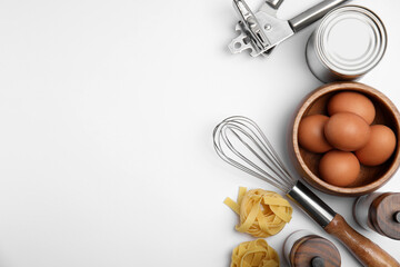 Cooking utensils and ingredients on white background, top view
