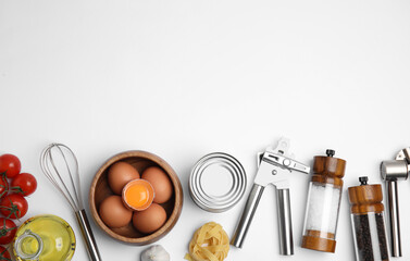 Cooking utensils and ingredients on white background, top view
