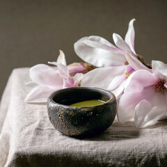 Obraz na płótnie Canvas Japanese matcha green tea powder in craft ceramic bowl