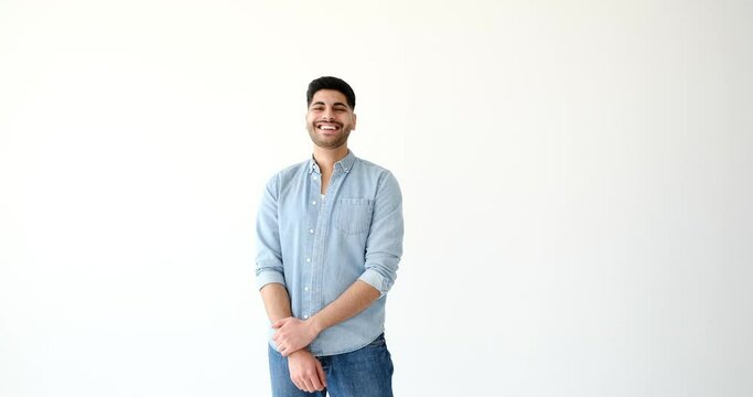 Portrait of cheerful young man laughing over white background