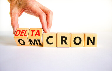 Covid-19 omicron or deltacron symbol. Doctor turns cubes and changes the word omicron to deltacron....