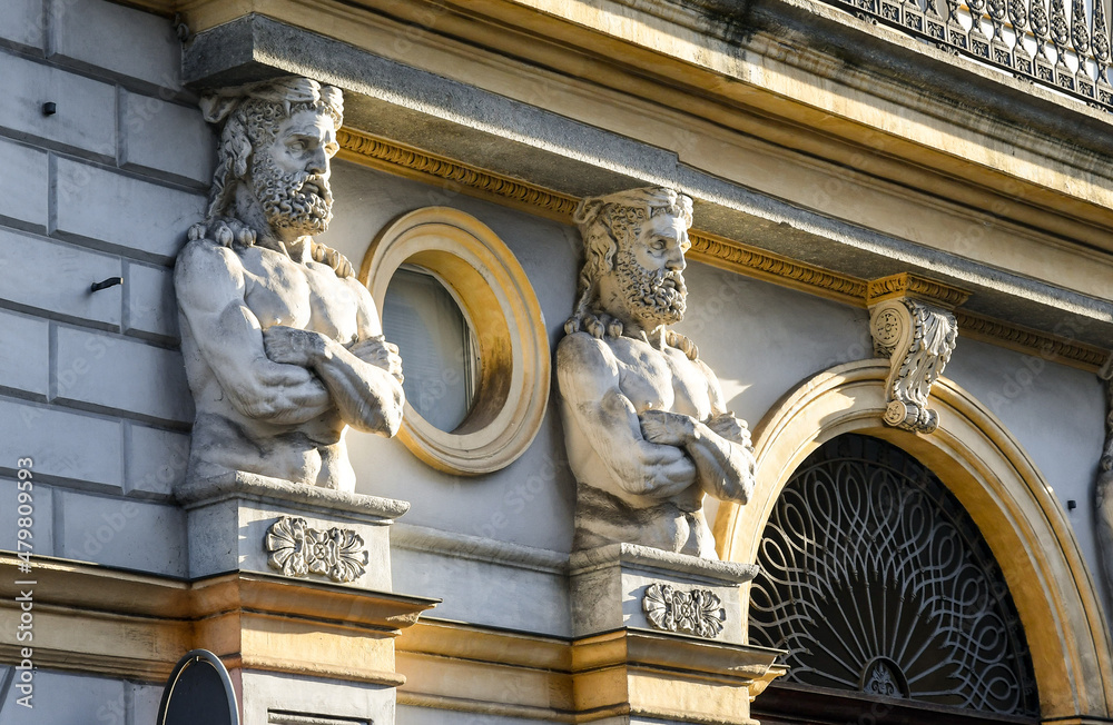 Sticker detail of the façade of an old palace with a pair of telamons on the sides of the entrance door, tur