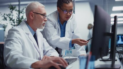 Medical Hospital: Two Doctors Look at X-Ray Scans on Computer Screen, Examining Tests Results, Diagnose Treatment. Health Care Clinic Research Laboratory with Diverse Team of Professionals Working - Powered by Adobe