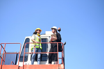 Team worker American women Work in an international shipping yard area Export and import delivery...