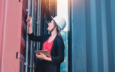 American women Work in an international shipping yard area Export and import delivery service with containers