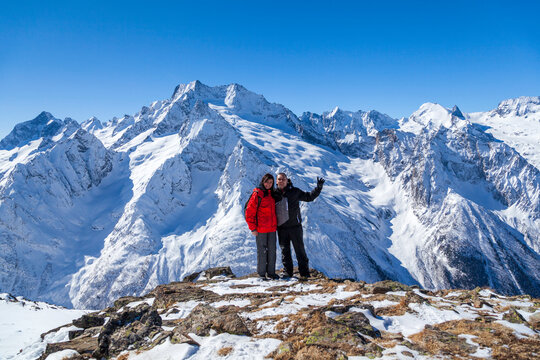 Couple in love on the background of snowy mountains