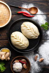 Traditional Korean steamed pie, pyanse or pigodi, on dark wooden background, top view