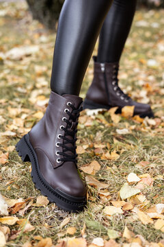 New collection of women's spring shoes. Slender female legs close-up in genuine leather boots.
