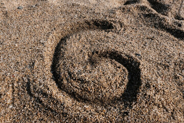 Fototapeta na wymiar English alphabet. Sand on the beach. The letter G