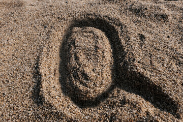 Fototapeta na wymiar English alphabet. Sand on the beach. The letter Q