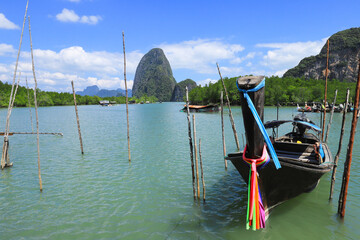 Thai traditional Longtail boat and beautiful Phang Nga Bay , Thailand .