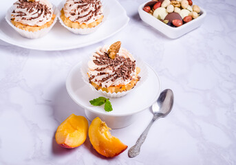 Tartlet cake filled with fruit cream with chocolate sprinkles on a plate