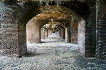 Fototapeta na wymiar Fort Jefferson, Dry Tortugas National Park, Florida Keys. Brick arches Gunrooms known as casemates, form a honeycomb of brick masonry arches. Linear or geometric perspective to the vanishing point. 