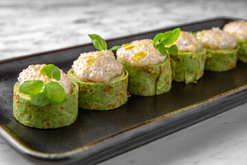 Cheese cream soup in a festive plate on a marble background. Restaurant banquet menu.