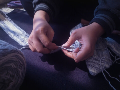 rural woman crochette knitting with crochet hook by hand.