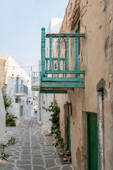 Paros island, Greece. Whitewashed building, empty narrow cobblestone street at Naousa old town