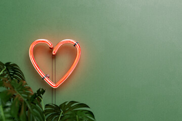 heart neon lamp on a green wall