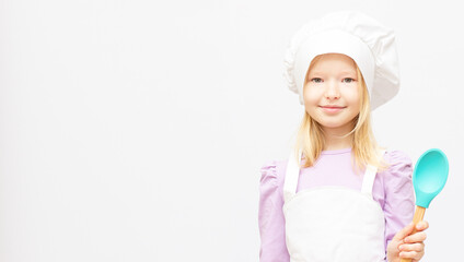 Beautiful little girl in chef uniform isolated on white