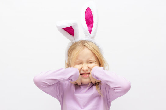 The little girl with pink ears bunny on white background.
