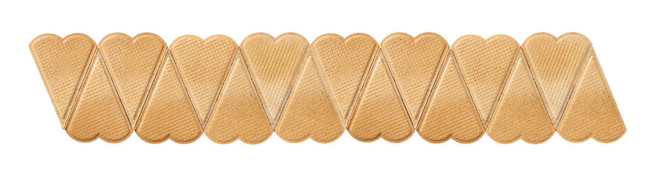 Row of sweet heart shaped wafers for dessert garnishing isolated on a white background. Thin flat waffle biscuits for ice cream decoration macro. Pastry pattern for Valentine day food design.