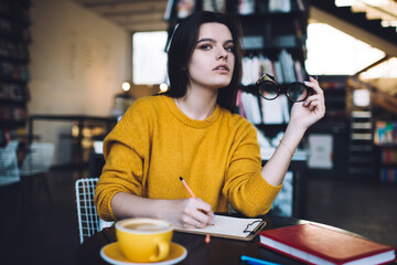 Thoughtful female working in spacious workplace