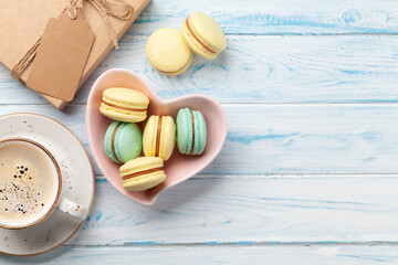 Homemade macaroons in gift box and coffee