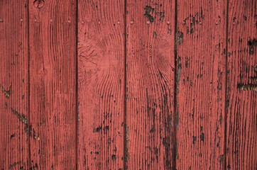 Old red cracked wooden wall close