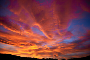 Dramatic sunset sky with clouds of beautiful orange and magenta colors