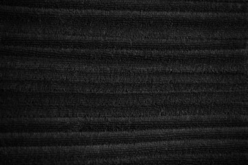 stacked black bathroom towels background. spa salon, barbershop