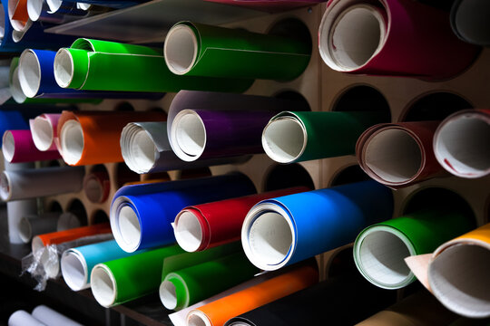 Decorative film for window display decoration in round tubes on the shelf.
