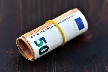 Roll of 1000 Euro in 50 Euro banknotes. Stack of money of Europe. Bunch of euro money. Stack of 50...