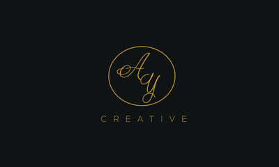 Fototapeta premium AY is a stylish logo with a creative design and golden color with blackish background.