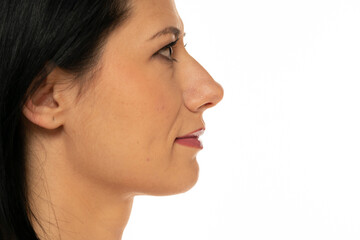 Closeup profile of middle aged woman on a white