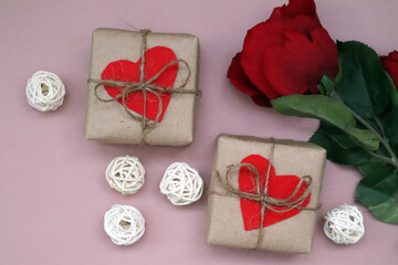 Craft gift box with red heart and craft ribbon on pink background. For celebrate. Valentines day conception.