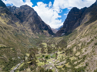 Aerial view of landscapes of Chupani village in middle of the Peruvian Andes. Small community in the Sacred Valley with some ruins and river.