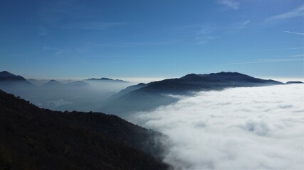 Fog on lake and mountains, northern Italy