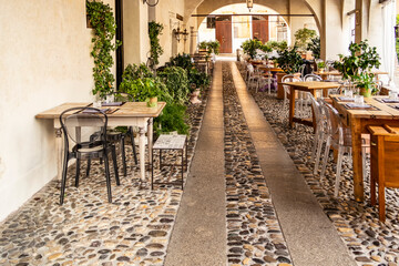 View under a portico with tables in Treviso, Veneto - Italy