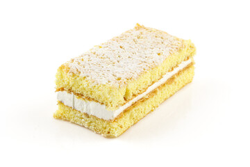 Slice of soft yello milk cream filled cake biscuit isolated on white background