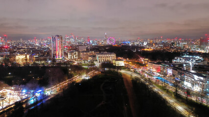 Aerial drone night shot from famous Hyde Park to illuminated city of London at Christmas, United Kingdom