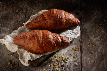 Two croissants close-up on a wooden table