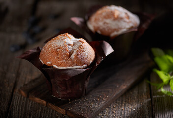 Muffins on a dark wooden background