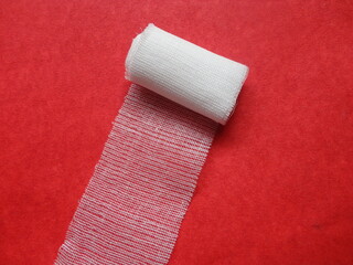 Gauze roll for injury treatment with red background