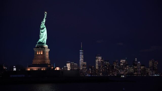 Statue of Liberty video by night with Manhattan
