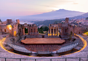 Sunset on the ancient roman-greek amphitheater with the Giardini Naxos bay in the back in Taormina,...