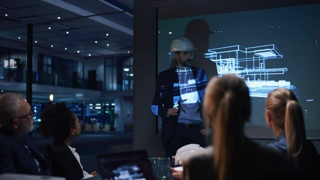 Real Estate Architectural Conference Meeting. Portrait of Chief Architect Presenting Building Construction to Investors. Projector TV Screen in Dark Room Shows 3D Model of Sustainable Housing Project