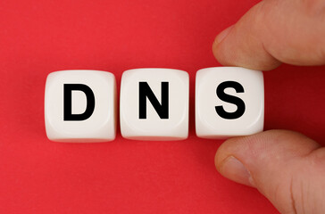 On the red surface, white cubes with the inscription - DNS