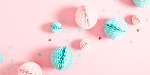 Festive pink background with confetti, paper decoration. Holiday concept on pastel pink background. Birthday, wedding, party. Flat lay, top view, copy space