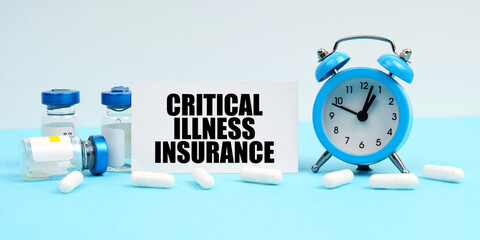 An alarm clock, pills, injections and a card with the inscription - Critical Illness Insurance